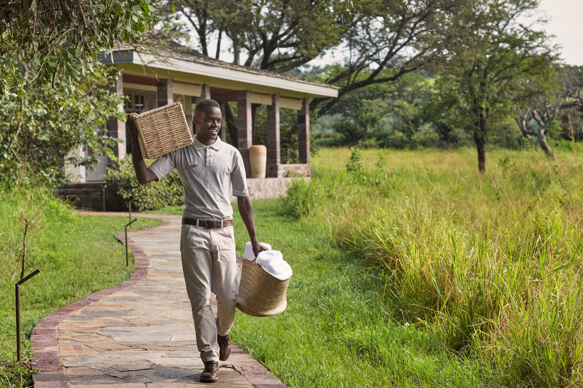 Singita Serengeti House Staff With Laundry © Singita Serengeti House - SINGITA